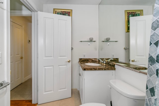 bathroom with tile patterned floors, vanity, and toilet