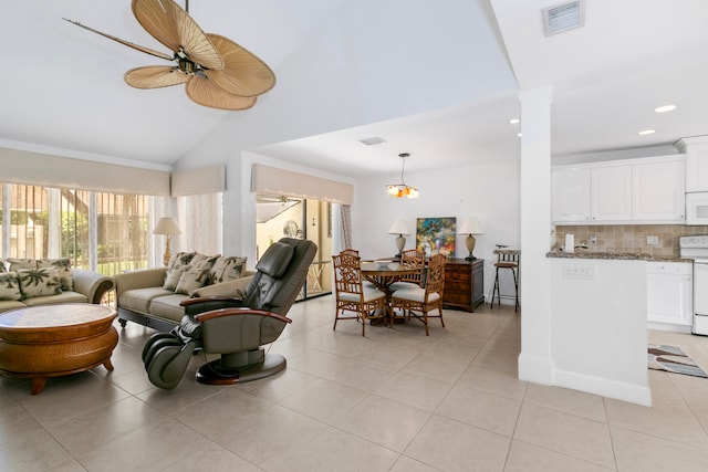 tiled living room featuring an inviting chandelier