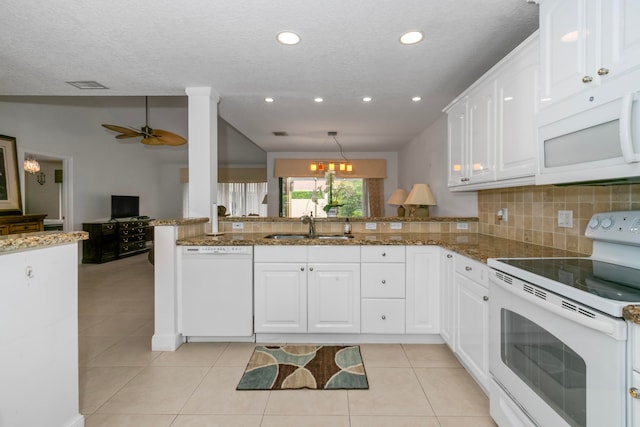 kitchen featuring white appliances, ceiling fan, sink, backsplash, and kitchen peninsula