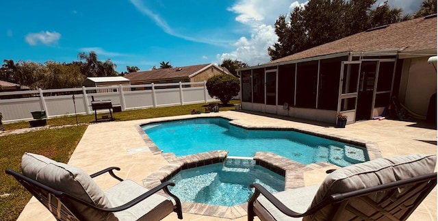 view of swimming pool with a sunroom, an in ground hot tub, and a patio area