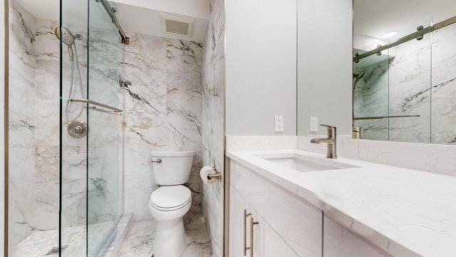 bathroom with toilet, vanity, and a shower with door