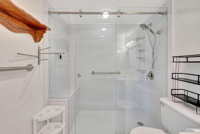 bathroom with toilet and an enclosed shower