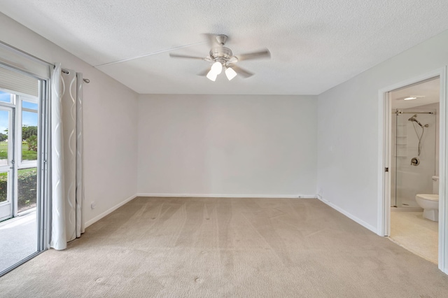 empty room featuring light carpet, ceiling fan, and a textured ceiling