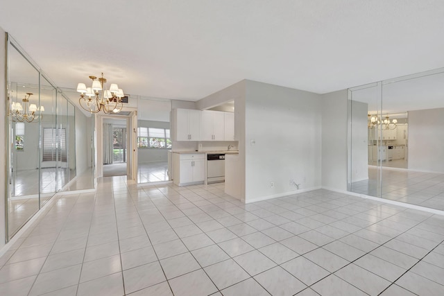 unfurnished living room with an inviting chandelier and light tile patterned floors