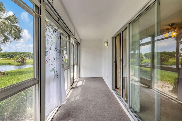 unfurnished sunroom featuring a water view