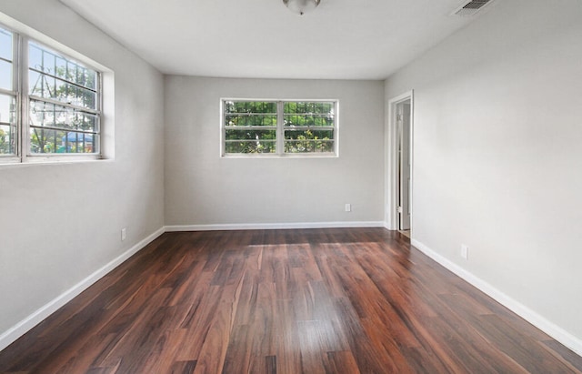 spare room featuring dark hardwood / wood-style flooring