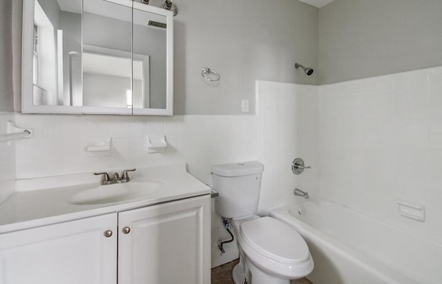 full bathroom with tile walls, shower / bathing tub combination, toilet, and vanity