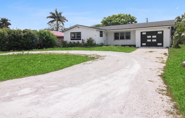 view of front of home with a garage and a front yard