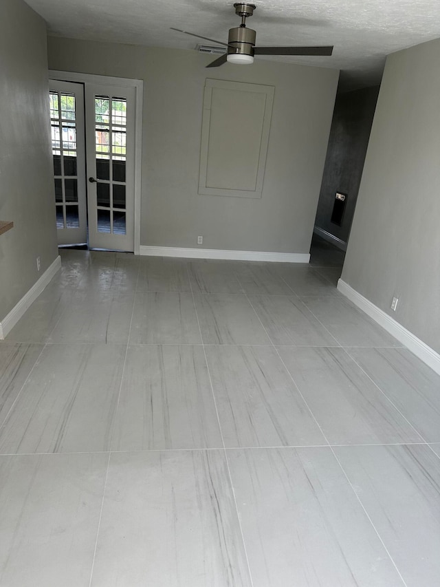 tiled empty room with ceiling fan