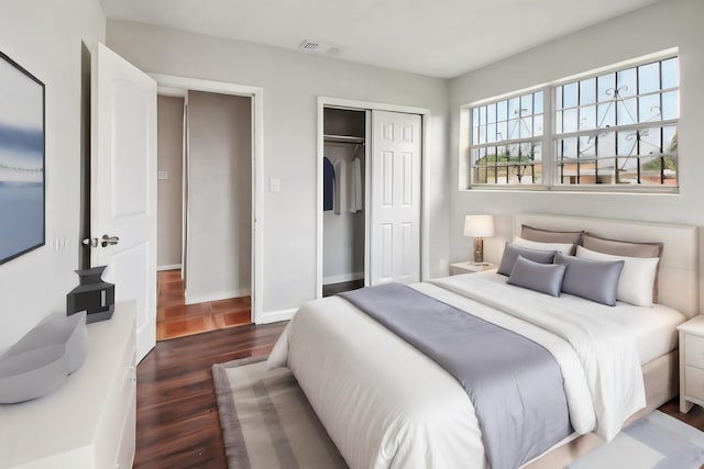 bedroom featuring dark wood-type flooring and a closet