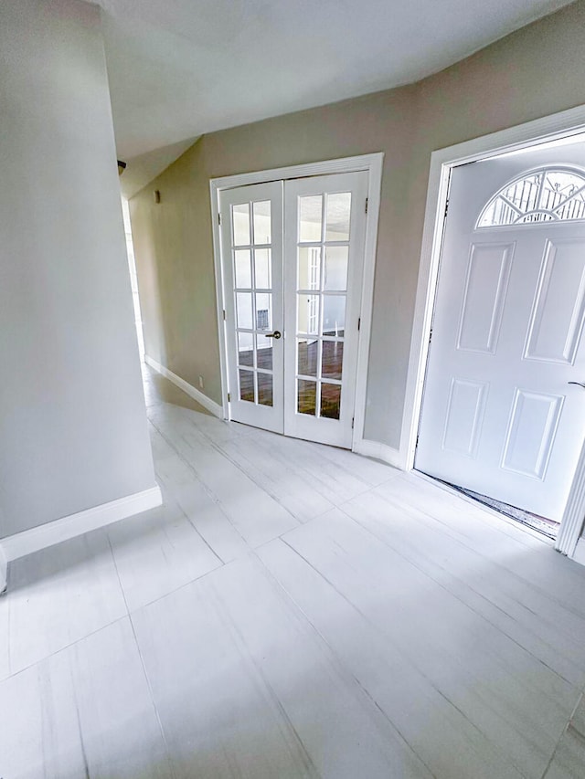 foyer with french doors and light tile patterned floors