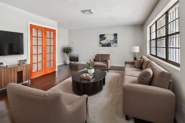 living room featuring french doors and dark hardwood / wood-style floors