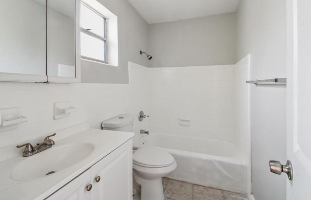 full bathroom featuring tile patterned flooring, tasteful backsplash, washtub / shower combination, vanity, and tile walls