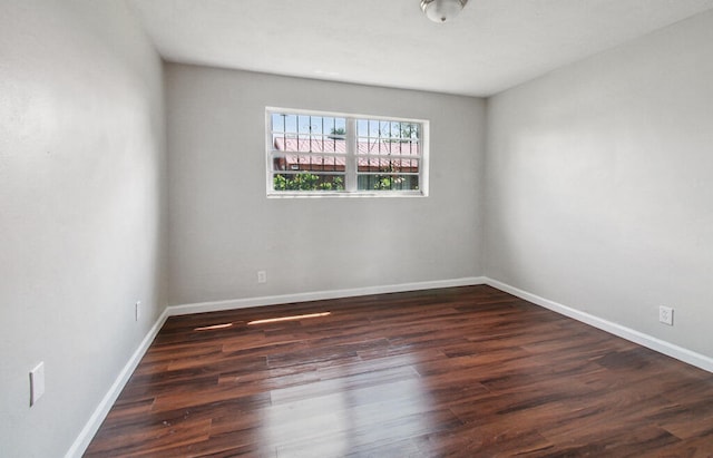 empty room featuring dark hardwood / wood-style flooring