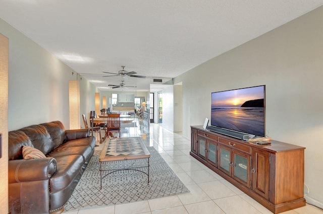 tiled living room with ceiling fan