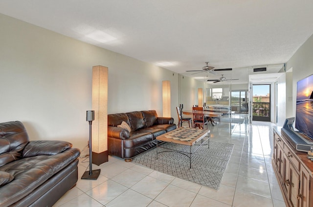 living room featuring light tile patterned floors and ceiling fan