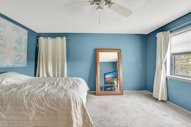 bedroom featuring a textured ceiling, carpet flooring, and ceiling fan