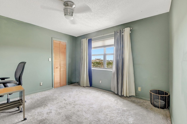 office with ceiling fan, a textured ceiling, and light carpet