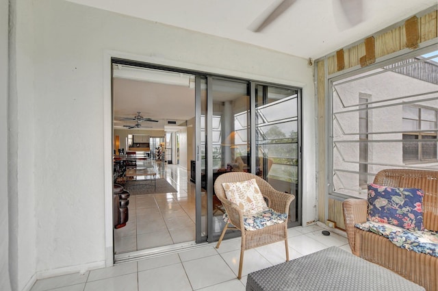 sunroom with ceiling fan and plenty of natural light