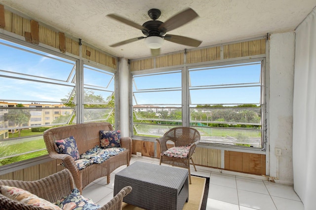 sunroom / solarium featuring ceiling fan and a wealth of natural light