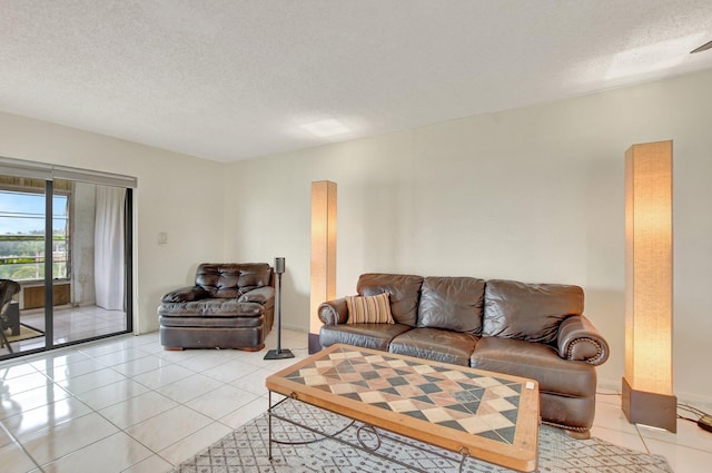 living room featuring a textured ceiling and light tile patterned floors