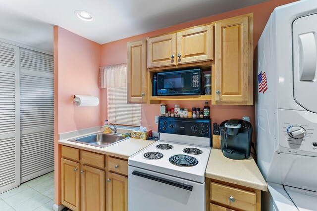 kitchen featuring white electric stove, light brown cabinetry, sink, light tile patterned flooring, and stacked washer / dryer