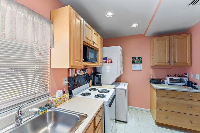 kitchen with white range with electric cooktop, light brown cabinets, light tile patterned floors, black microwave, and sink