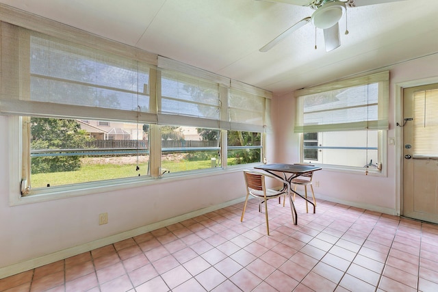 unfurnished sunroom with lofted ceiling, a wealth of natural light, and ceiling fan