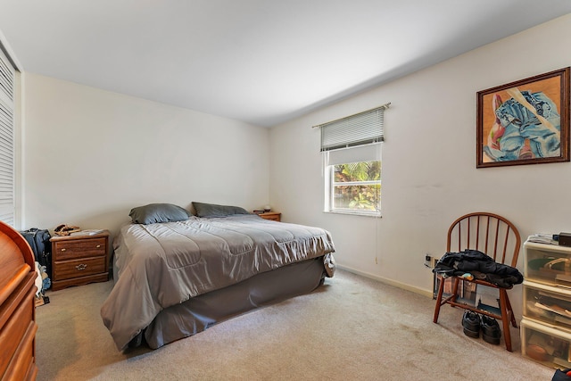 bedroom featuring light carpet