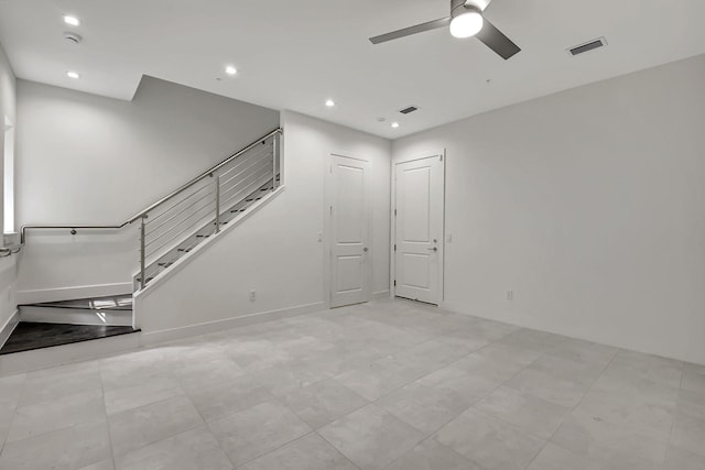 unfurnished living room with light tile patterned floors and ceiling fan