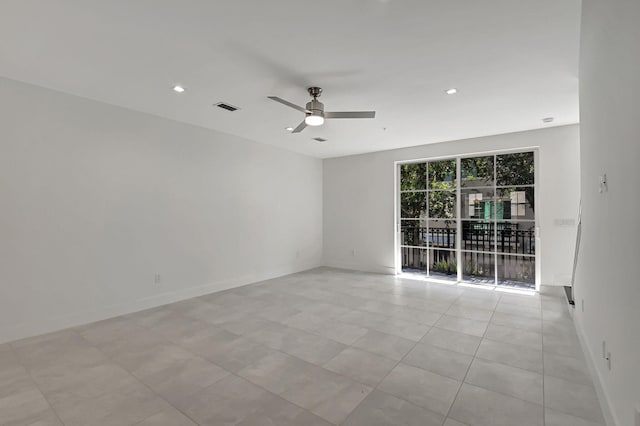 spare room with light tile patterned flooring and ceiling fan