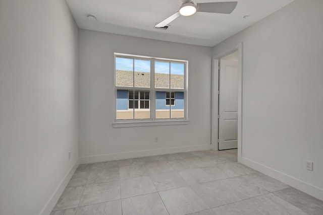 empty room with light tile patterned floors and ceiling fan