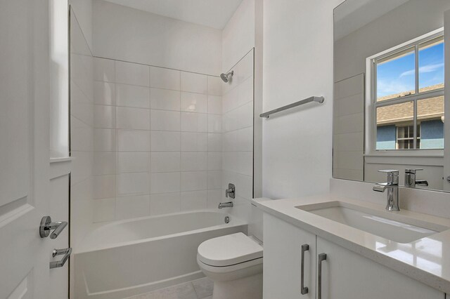 full bathroom with tile patterned flooring, toilet, vanity, and tiled shower / bath