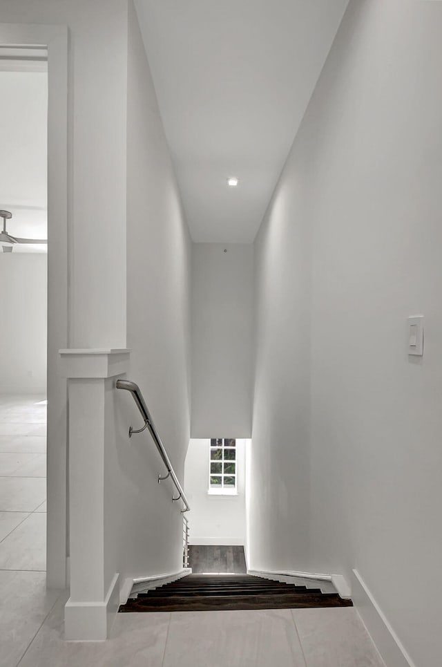 staircase featuring light tile patterned flooring