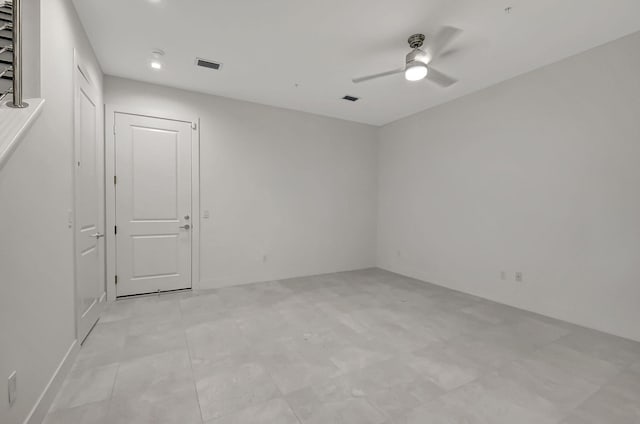 tiled spare room with ceiling fan