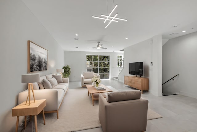 living room featuring ceiling fan with notable chandelier and tile patterned floors