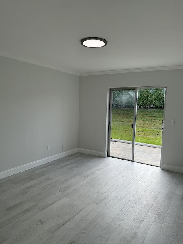 unfurnished room with ornamental molding and light hardwood / wood-style floors