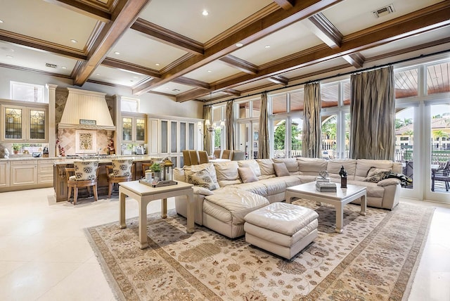 tiled living room with plenty of natural light, beamed ceiling, coffered ceiling, and a notable chandelier