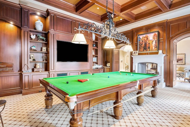 recreation room with wood walls, a multi sided fireplace, coffered ceiling, beam ceiling, and light carpet