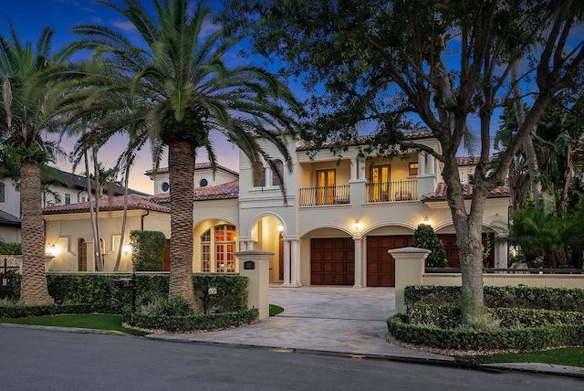 mediterranean / spanish-style house with a balcony and a garage