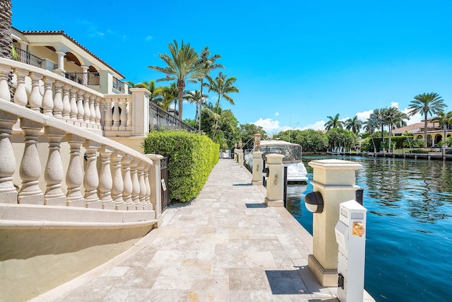 view of patio / terrace featuring a water view and a balcony