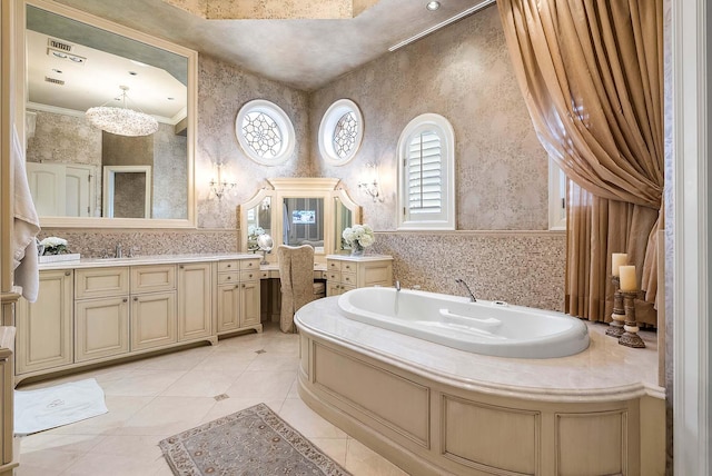 bathroom featuring vanity, a bath, an inviting chandelier, crown molding, and tile patterned flooring