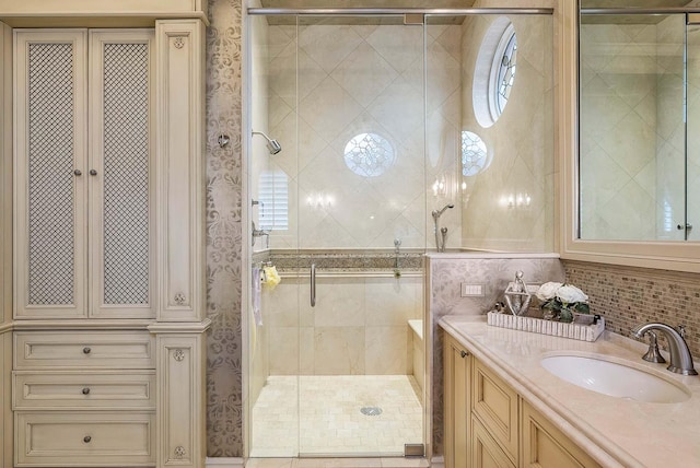 bathroom featuring vanity, tile walls, a shower with shower door, and plenty of natural light