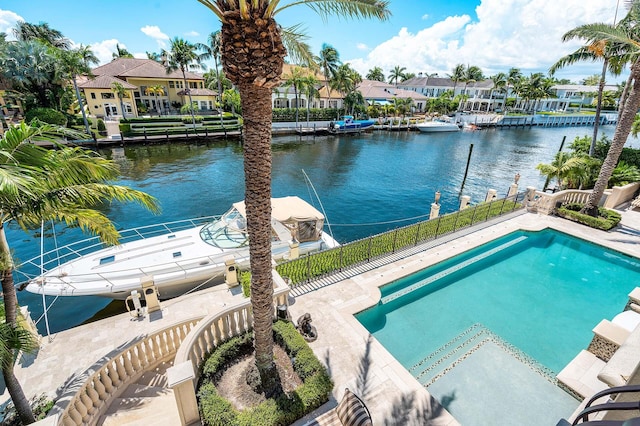 view of pool with a water view and a dock