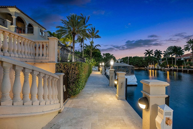 dock area featuring a water view and a balcony