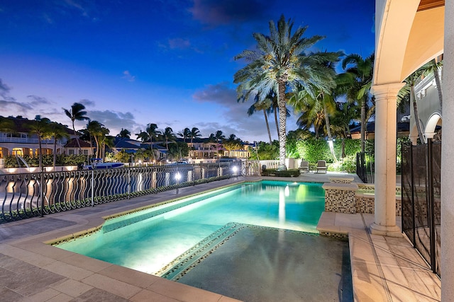 pool at dusk with a patio