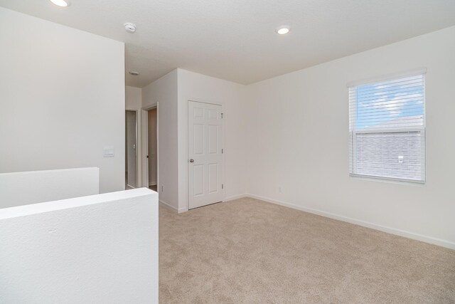 spare room with light colored carpet