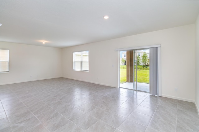 spare room featuring recessed lighting, baseboards, and light tile patterned flooring