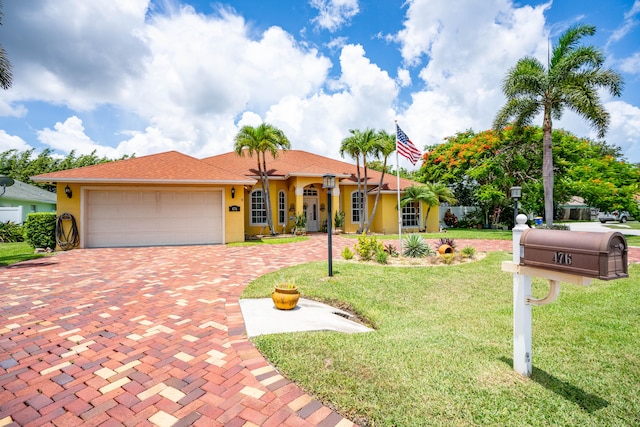 view of front of home featuring a garage and a front yard