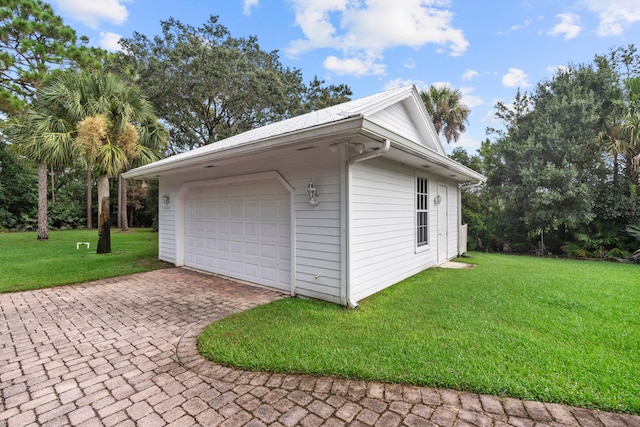 garage featuring a lawn